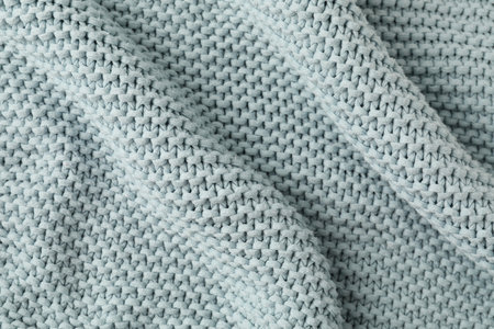 Texture of light blue knitted fabric as background, top viewの写真素材