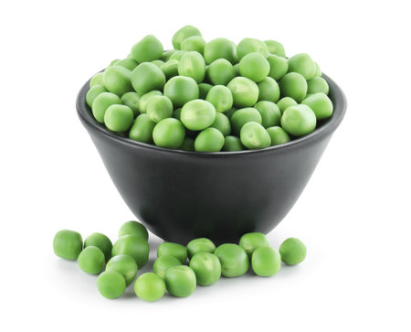 Fresh green peas in bowl isolated on whiteの写真素材