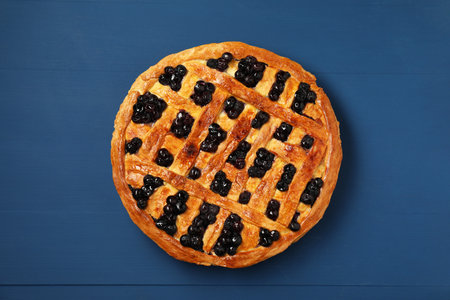 Tasty homemade pie with blueberries on blue wooden table, top viewの写真素材