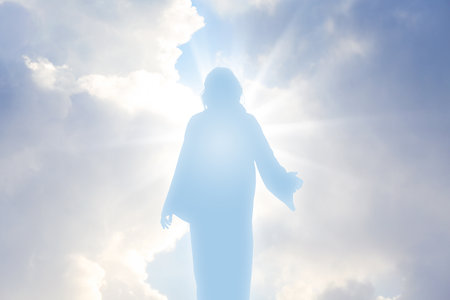 Silhouette of Jesus Christ in sunlight among clouds in skyの写真素材