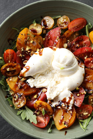 Fresh delicious burrata salad on table, top view
