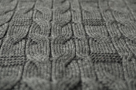 Texture of gray knitted fabric as background, closeup