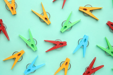 Many colorful clothespins on turquoise background, flat layの写真素材