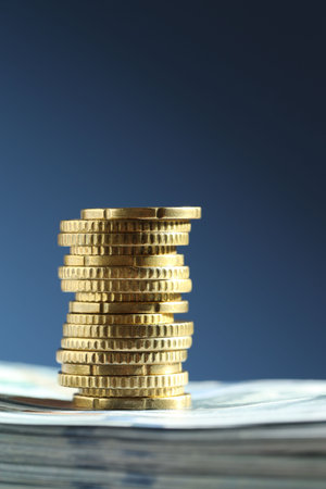 Stack of euro coins on blue backgroundの写真素材