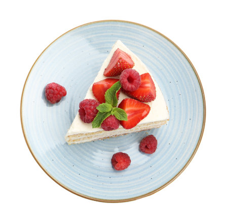 Piece of tasty sponge cake with fresh berries and mint isolated on white, top viewの写真素材