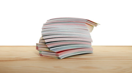 Stack of business cards on wooden table against white background