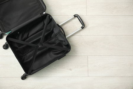 Open empty suitcase on floor indoors, top view. Space for text