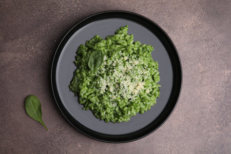 Delicious spinach risotto with parmesan cheese on grey table, top viewの写真素材