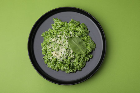 Delicious spinach risotto with parmesan cheese on light green background, top viewの写真素材