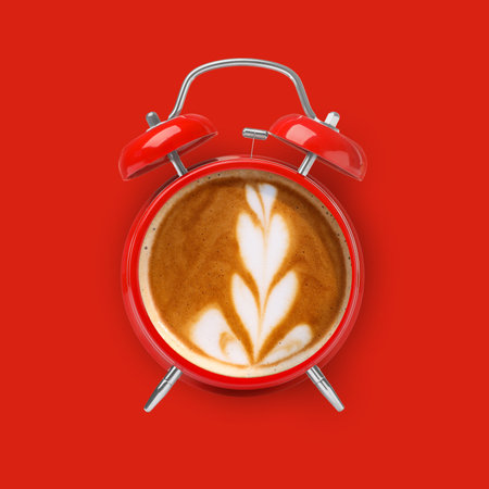 Bright alarm clock with coffee instead of dial on red background, top viewの写真素材