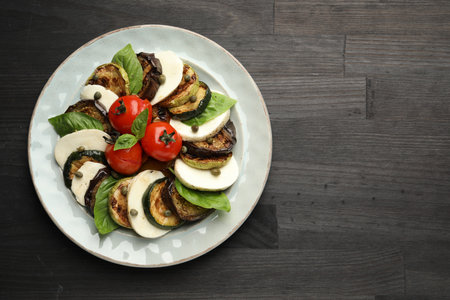 Tasty salad with grilled vegetables and mozzarella cheese on wooden table, top view. Space for textの写真素材