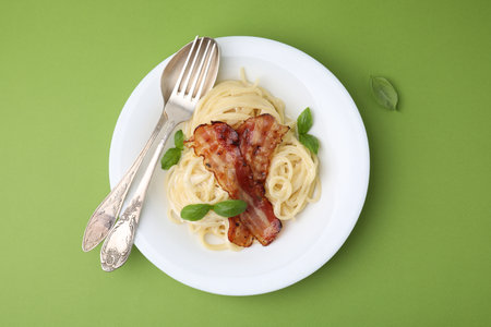 Delicious pasta Carbonara served on green table, top viewの写真素材