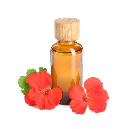 Bottle of geranium essential oil and beautiful flowers isolated on whiteの写真素材