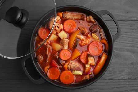 Tasty homemade stew with vegetables on grey wooden table, top viewの写真素材