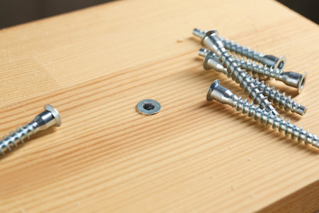 Many screws and wooden plank, closeup viewの写真素材