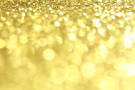 Beautiful shiny golden glitter as background, closeup