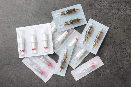 Many disposable cartridge systems for permanent makeup on grey background, top viewの写真素材