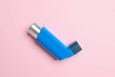 Asthma inhaler on pink background, top viewの写真素材