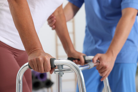 Physiotherapist working with senior patient in rehabilitation center, closeupの写真素材