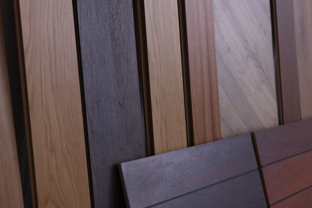 Many different samples of wooden flooring as background, closeup