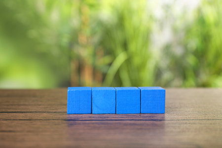 Many blank colorful cubes on wooden table outdoorsの写真素材