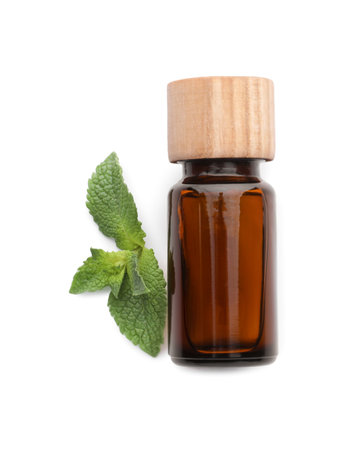 Bottle of essential oil and mint isolated on white, top view