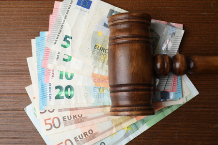Alimony. Judge's gavel and money on wooden table, flat layの写真素材