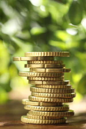 Stack of euro coins on wooden tableの写真素材