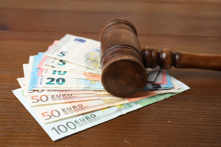 Alimony. Judge's gavel and money on wooden table, closeupの写真素材