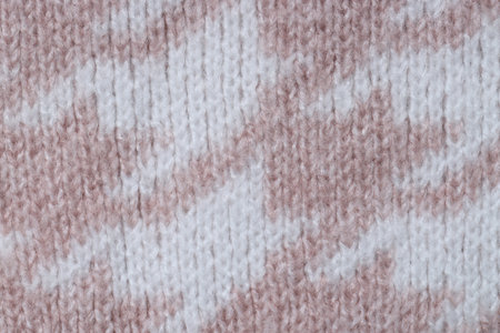 Texture of knitted fabric with pattern as background, top view