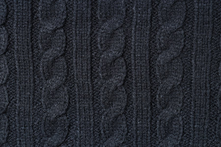 Texture of black knitted fabric as background, top view