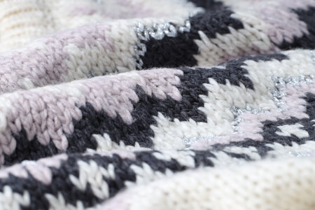 Texture of knitted fabric with pattern as background, closeup