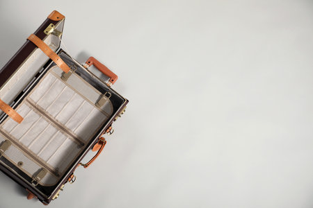 Open empty suitcase on light grey background, top view. Space for textの写真素材