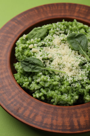 Delicious spinach risotto with parmesan cheese on light green backgroundの写真素材
