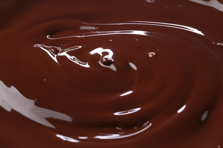 Delicious melted chocolate as background, closeup viewの写真素材
