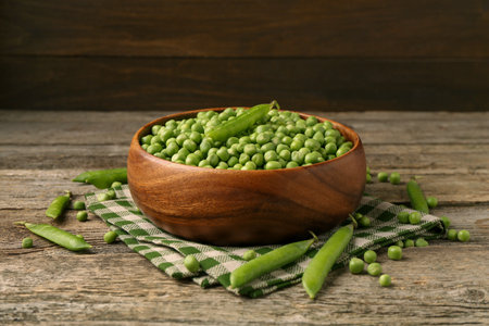 Fresh green peas and pods on wooden tableの写真素材