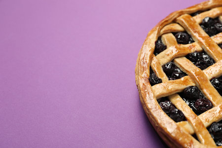 Tasty homemade pie with blueberries on purple table, closeup. Space for textの写真素材