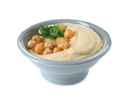 Delicious hummus with olive oil, chickpeas and parsley isolated on whiteの写真素材