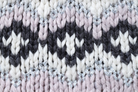 Texture of knitted fabric with pattern as background, top viewの写真素材
