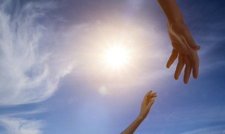 God's help and support. Human reaching for hand from heaven
