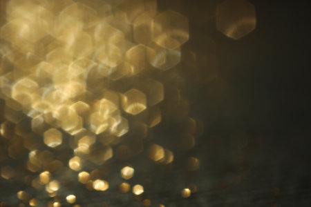 Beautiful shiny golden glitter on black background, closeupの写真素材