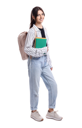 Cute teenage girl with backpack and books on white backgroundの写真素材