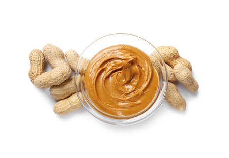 Tasty peanut butter and nuts isolated on white, top view