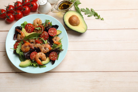 Delicious shrimp salad and ingredients on white wooden table, flat lay. Space for textの写真素材