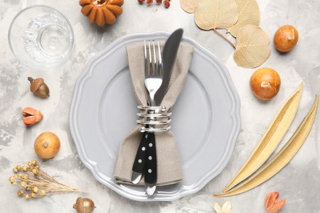 Stylish place setting with autumnal decor on gray textured table