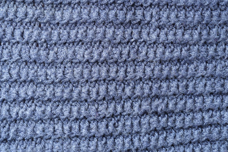 Texture of blue knitted fabric as background, top view