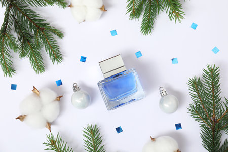 Christmas composition with perfume bottle on white background, flat lay