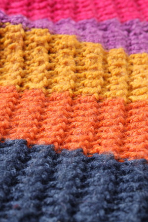 Texture of colorful knitted fabric as background, closeup