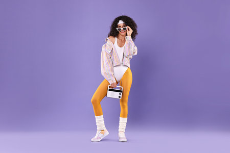 Aerobics. Woman with radio receiver on purple backgroundの写真素材