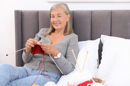 Knitting activity on bed at homeの写真素材